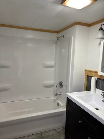 a bathroom with a bathtub a sink and a shower