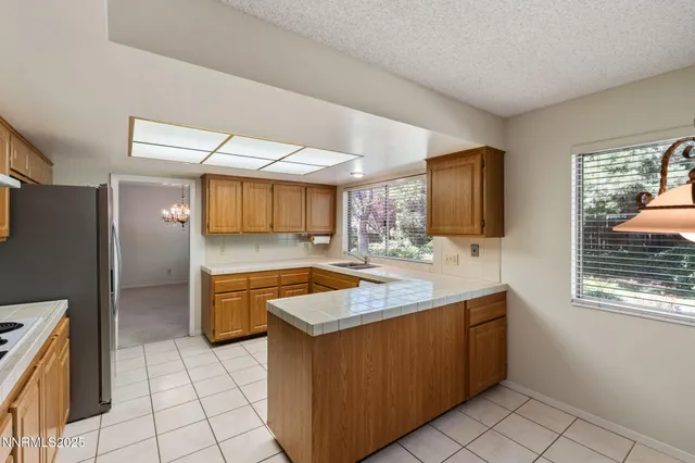 a kitchen with stainless steel appliances granite countertop a sink counter space cabinets and a window