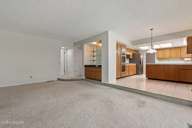 an empty room with furniture and windows
