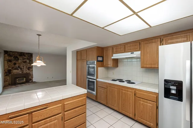 a kitchen with stainless steel appliances a refrigerator sink and stove