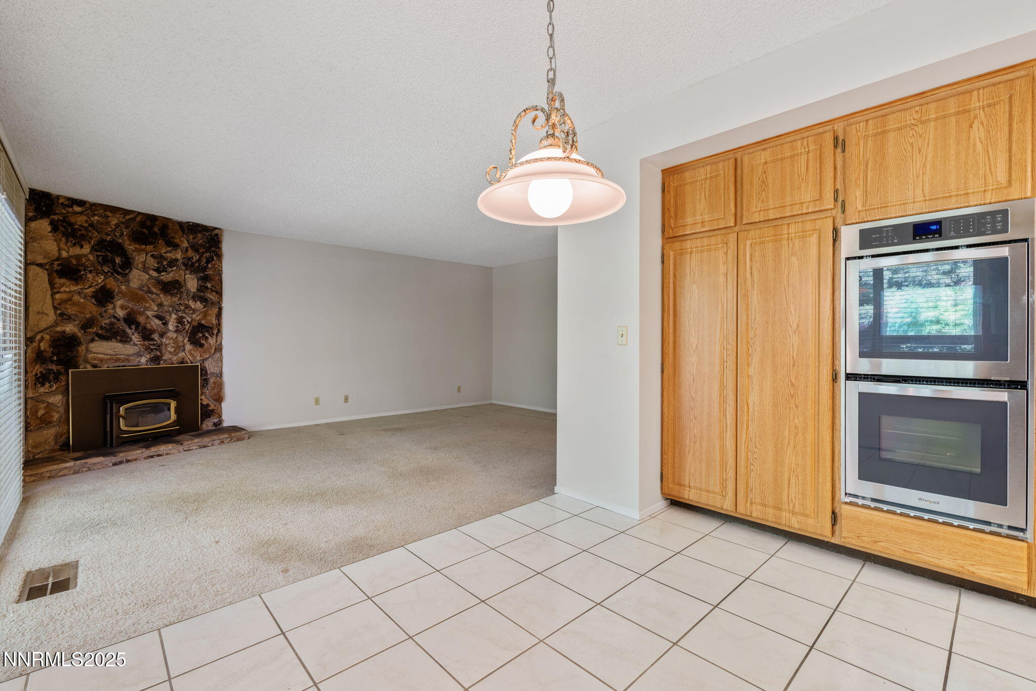 4899 Cool Springs Drive Reno, NV 89509 - Photo 20 of 41 a view of an empty room with a fireplace and a window