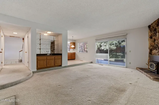 a large bed sitting in a room next to a window