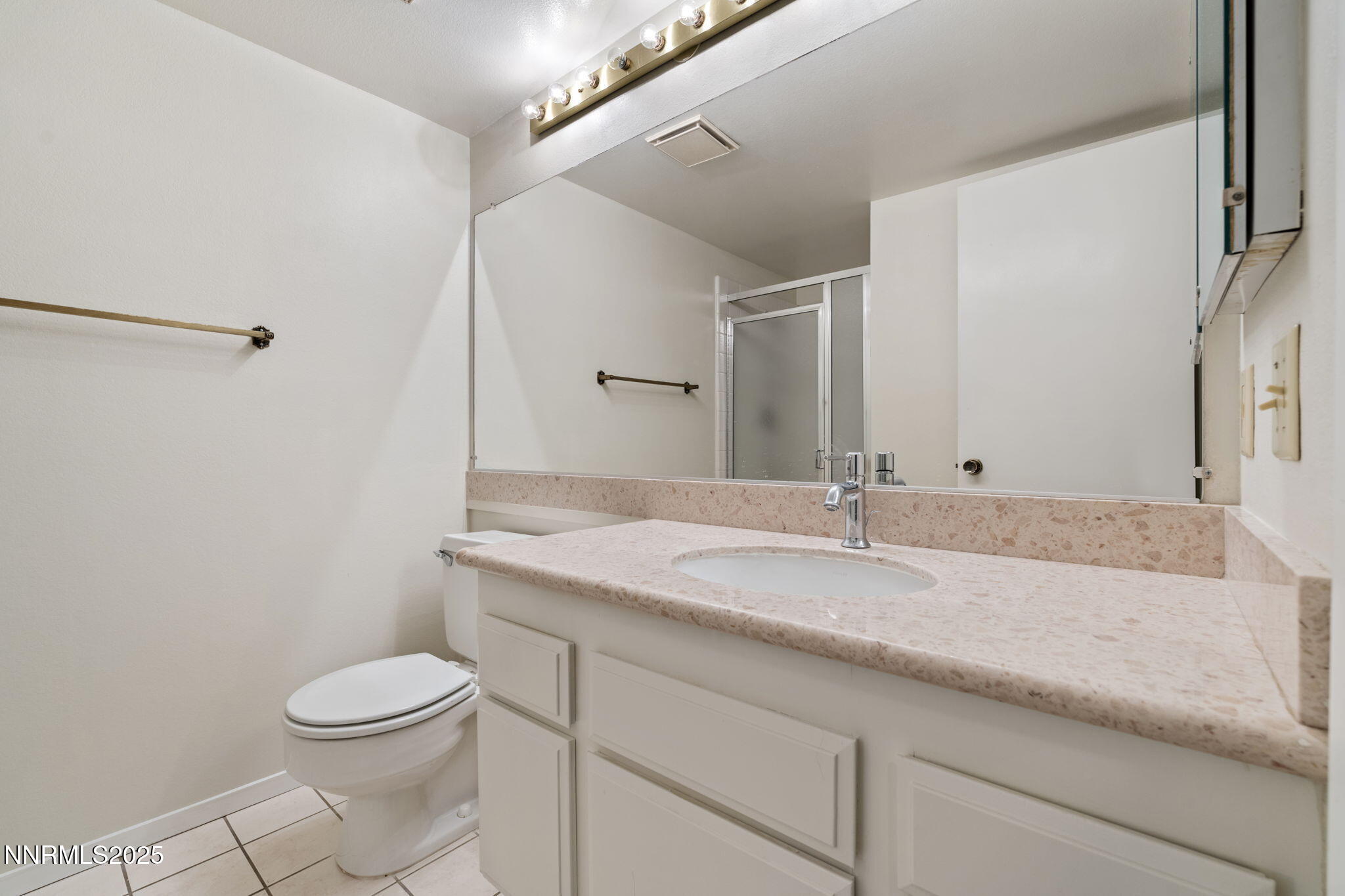 4899 Cool Springs Drive Reno, NV 89509 - Photo 32 of 41 a bathroom with a granite countertop sink a toilet and a mirror