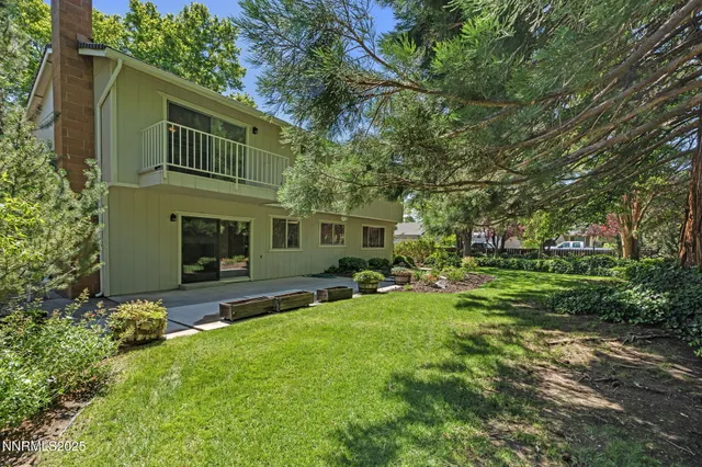 a view of a house with a yard and sitting area