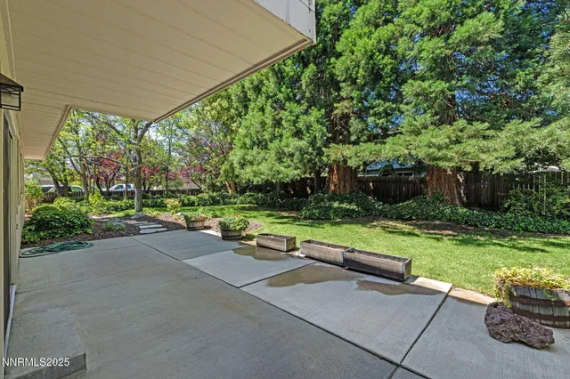 a view of backyard with outdoor seating and green space