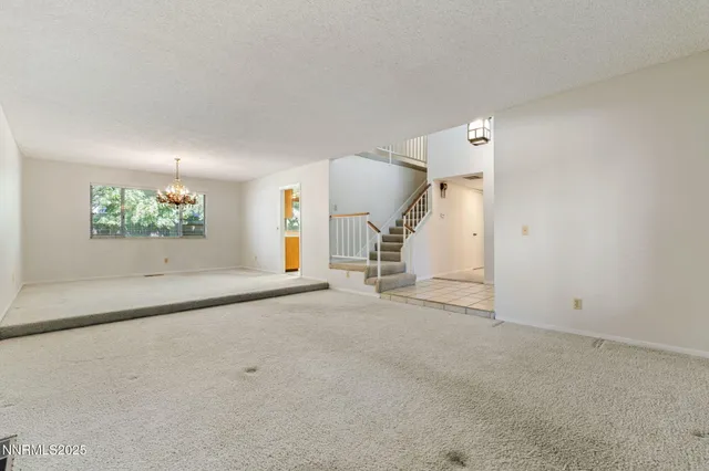 an empty room with a empty space and windows