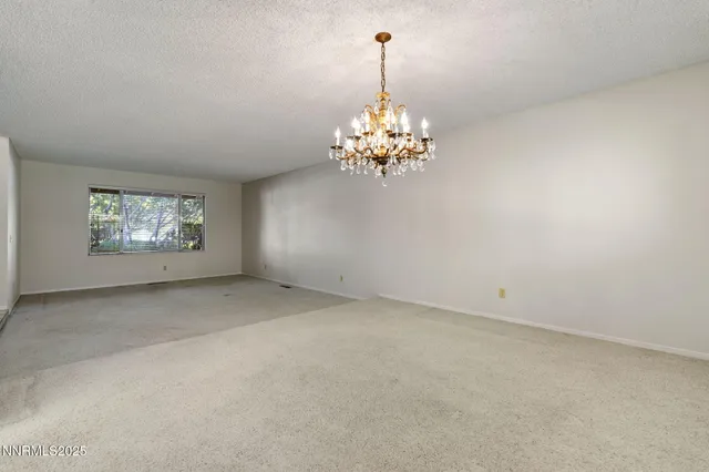 a view of a chandelier in big room and chandelier
