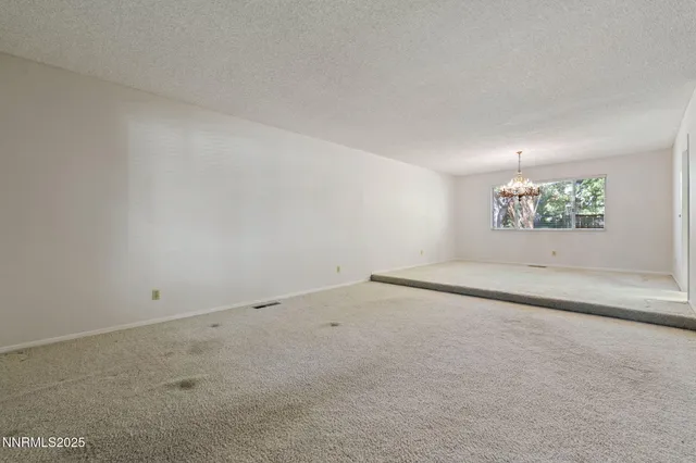 an empty room with a empty space and windows