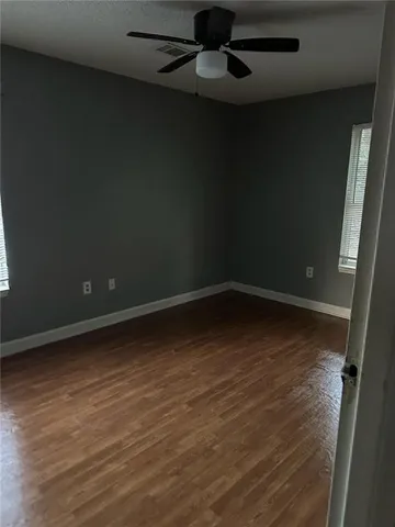 a view of a room with wooden floor and cabinet