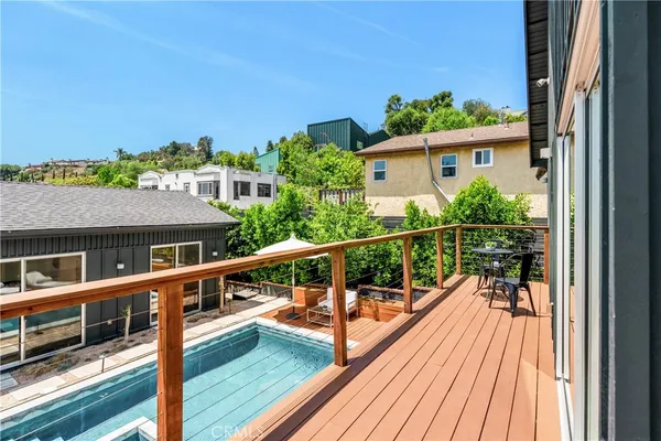 a view of a balcony with wooden floor and fence