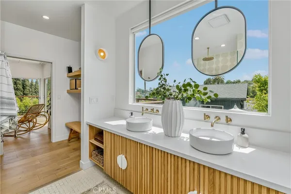 a bathroom with a double vanity sink and a mirror
