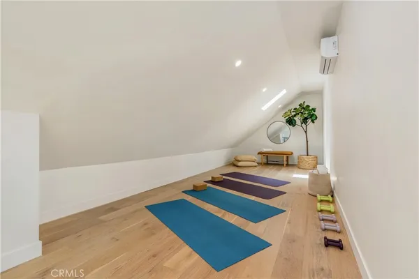 a room with pool table and wooden floor