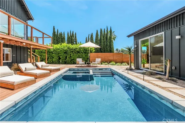 a swimming pool with outdoor seating and yard