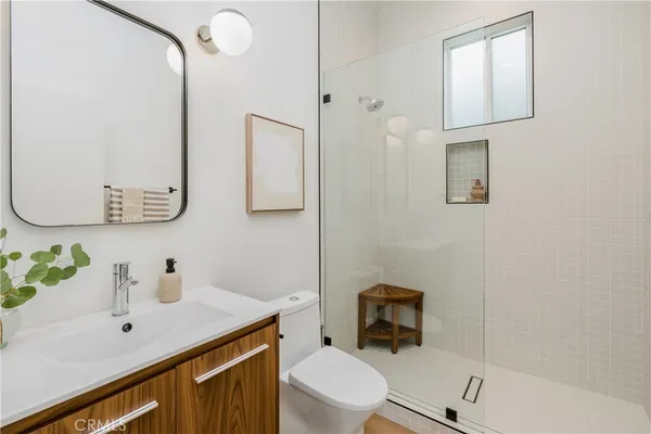 a bathroom with a sink a toilet and mirror