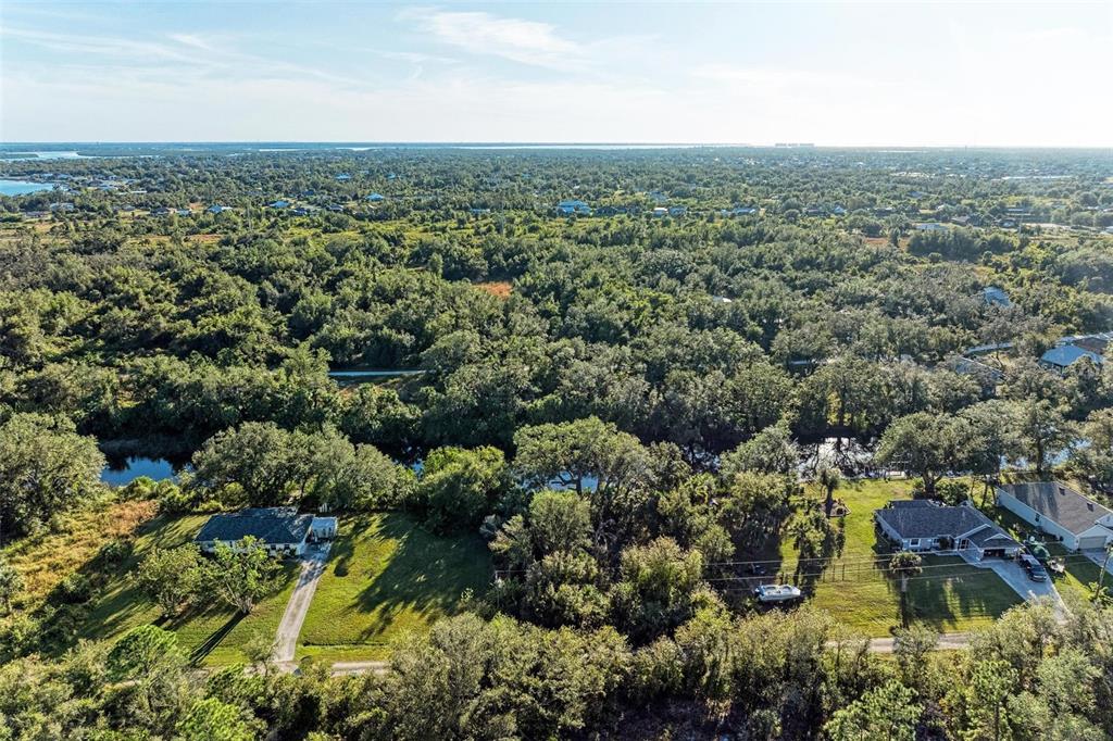 27401 Neaptide Drive Punta Gorda, FL 33983 - Photo 13 of 16 an aerial view of residential houses with outdoor space and trees