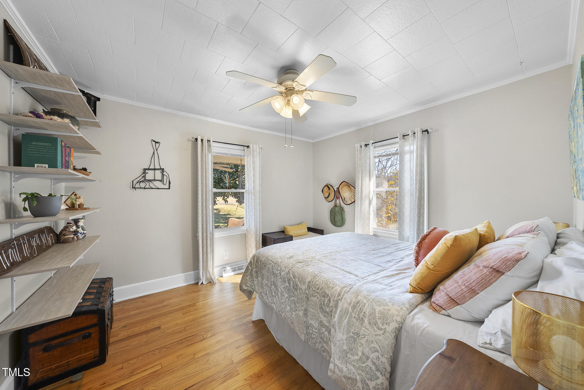 322 Robbins Road Durham, NC 27703 - Photo 13 of 48 a bedroom with a bed and wooden floor