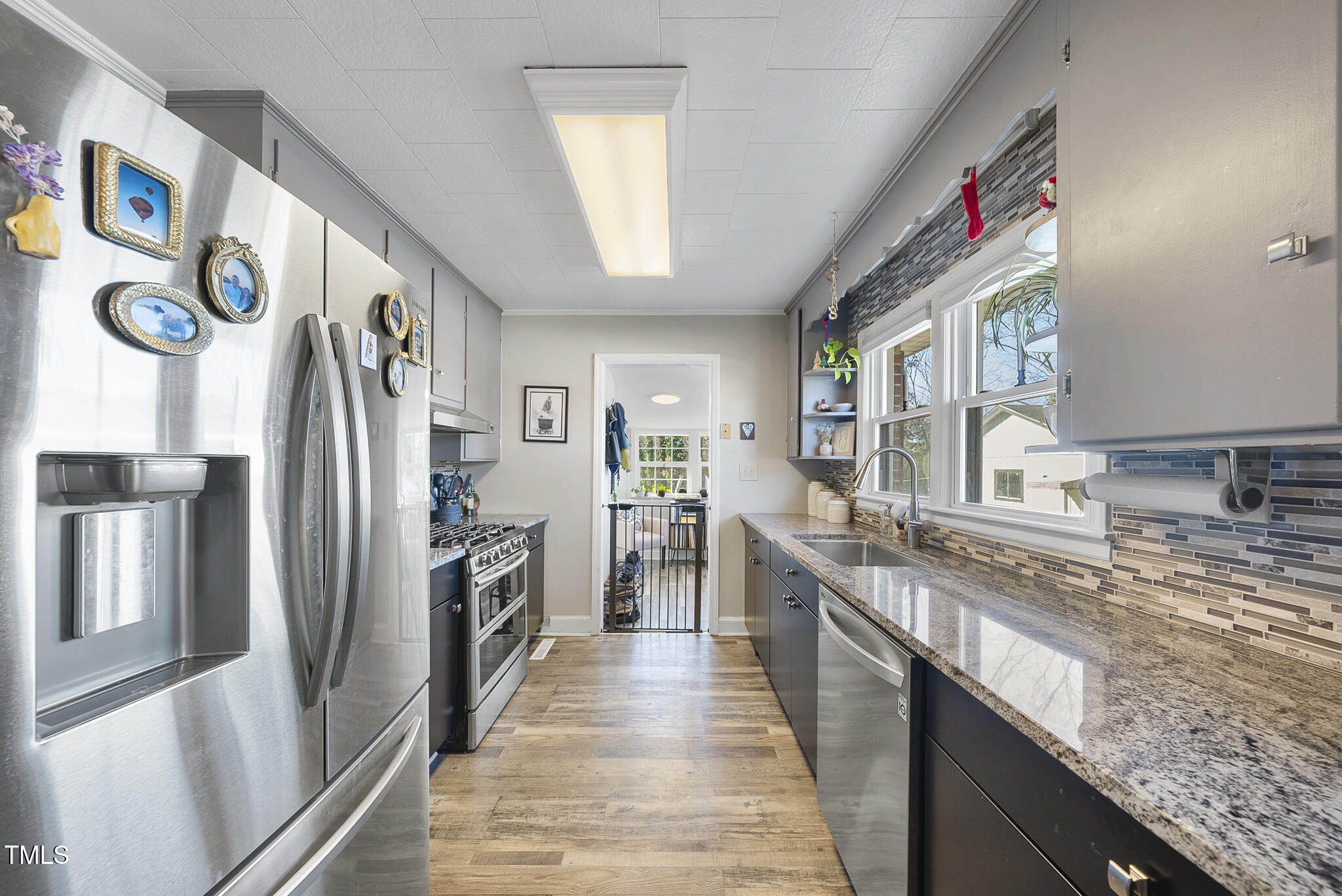 322 Robbins Road Durham, NC 27703 - Photo 21 of 48 a kitchen with stainless steel appliances granite countertop a refrigerator and a sink