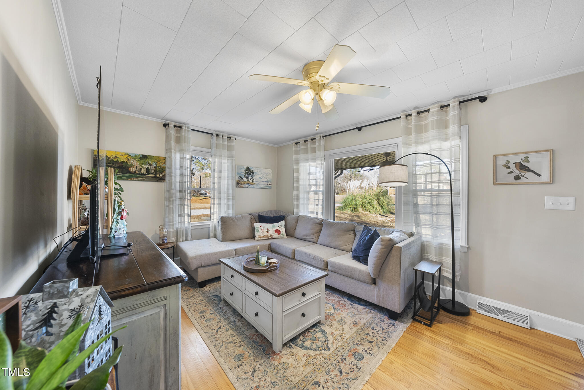 322 Robbins Road Durham, NC 27703 - Photo 7 of 48 a living room with furniture and a flat screen tv