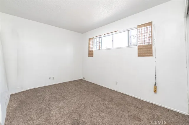 a view of an empty room with windows