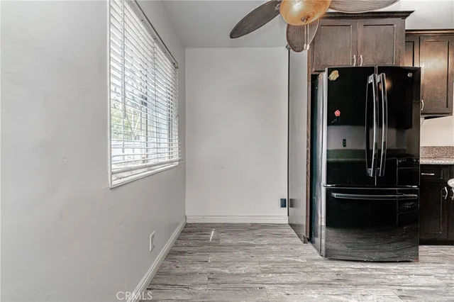 a view of hallway with stairs and wooden floor