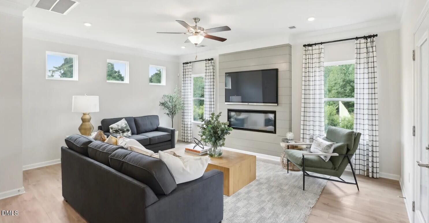 74 Floating Brg Trail Lillington, NC 27546 - Photo 2 of 7 a living room with furniture a flat screen tv and a large window