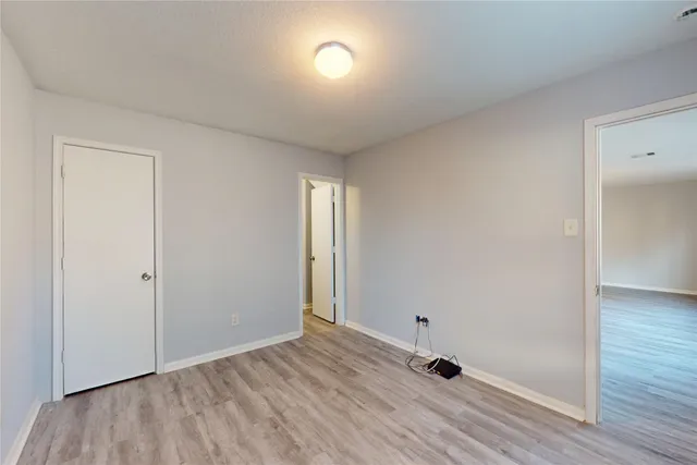 a view of an empty room and wooden floor