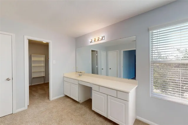 a room with a bed and a dresser