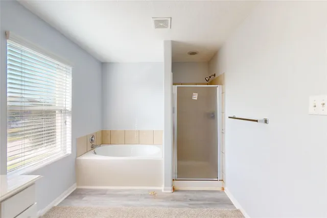 a bathroom with a bathtub and shower