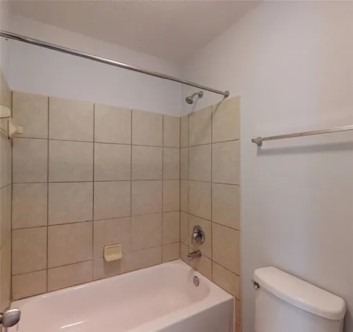 a bathroom with a bathtub and toilet