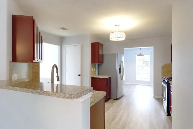 a kitchen with a sink and a refrigerator