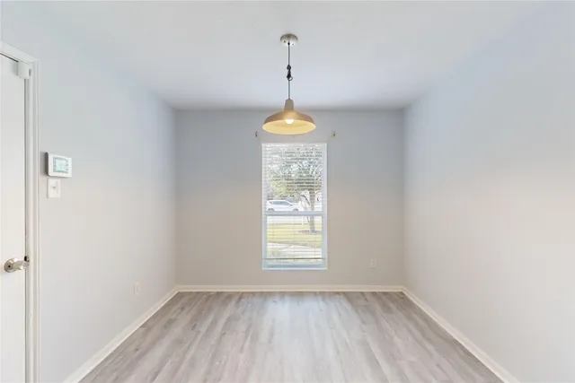 a room that has a window in it with a chandelier
