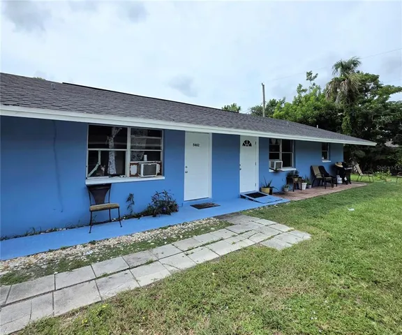 a view of a house with table and chairs