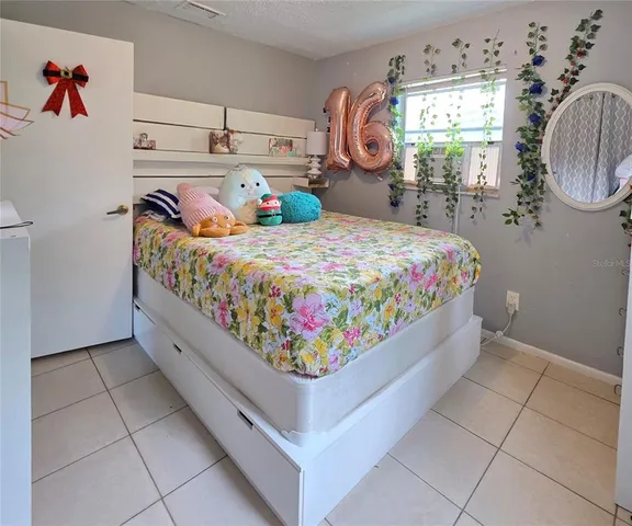 a bed room with a bed and a chair