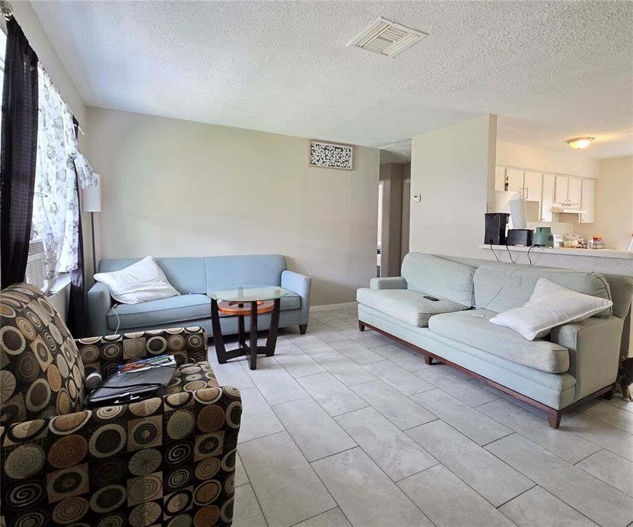 5462 Tenth Avenue Fort Myers, FL 33907 - Photo 14 of 20 a living room with furniture and a flat screen tv