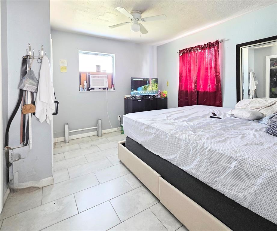 5462 Tenth Avenue Fort Myers, FL 33907 - Photo 17 of 20 a bedroom with a bed and a dresser