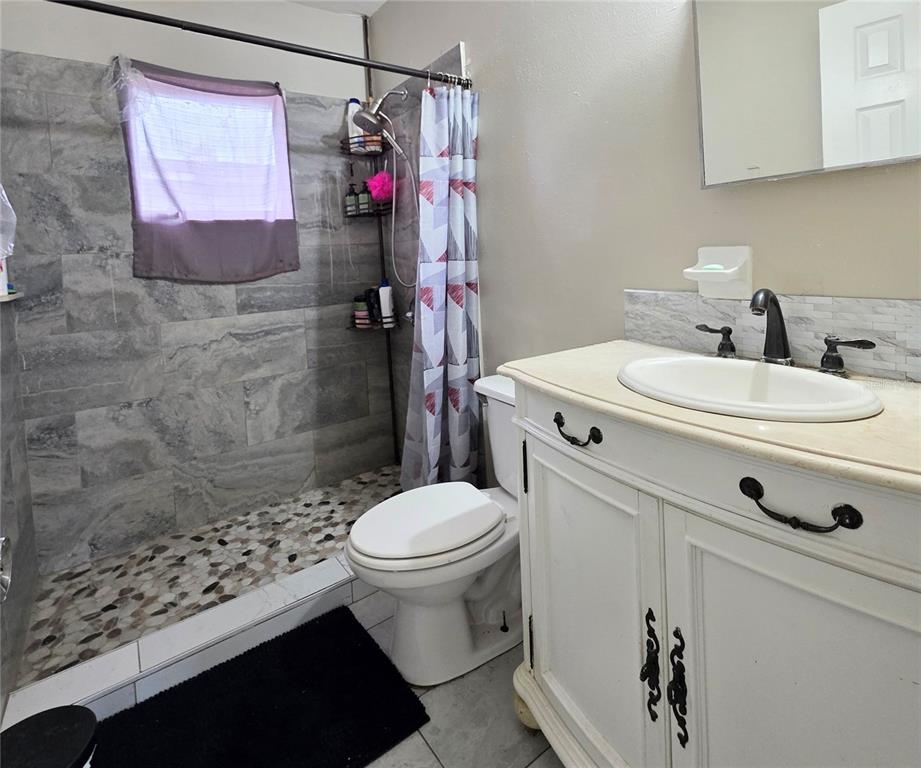 5462 Tenth Avenue Fort Myers, FL 33907 - Photo 18 of 20 a bathroom with a sink a toilet and shower