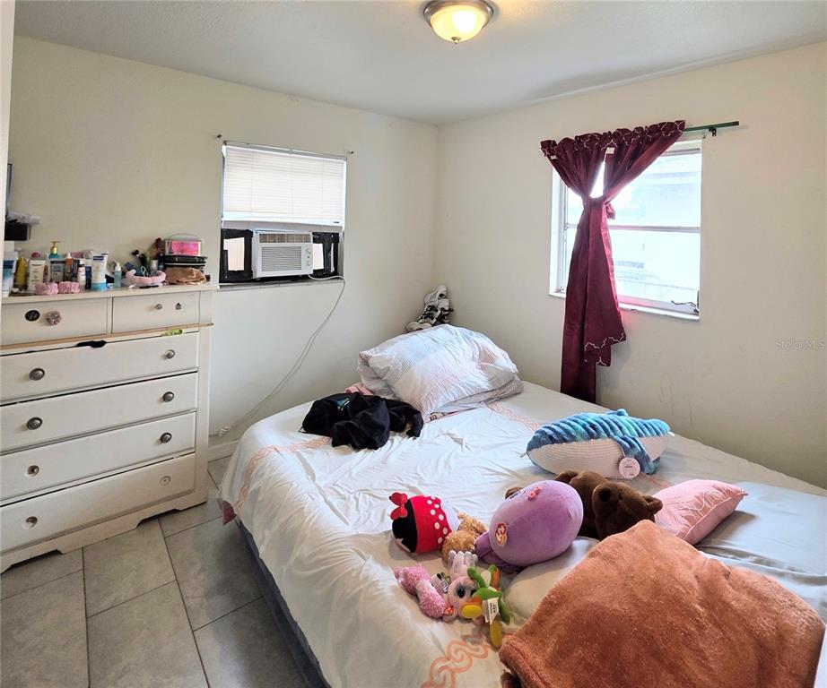 5462 Tenth Avenue Fort Myers, FL 33907 - Photo 19 of 20 a bedroom with two bed and a window
