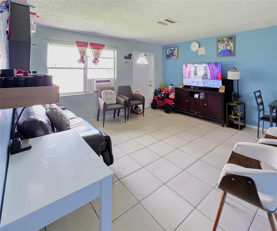 5462 Tenth Avenue Fort Myers, FL 33907 - Photo 4 of 20 a living room with furniture and a flat screen tv