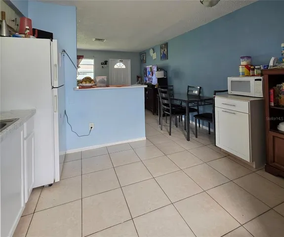 a view of kitchen with furniture and white appliances