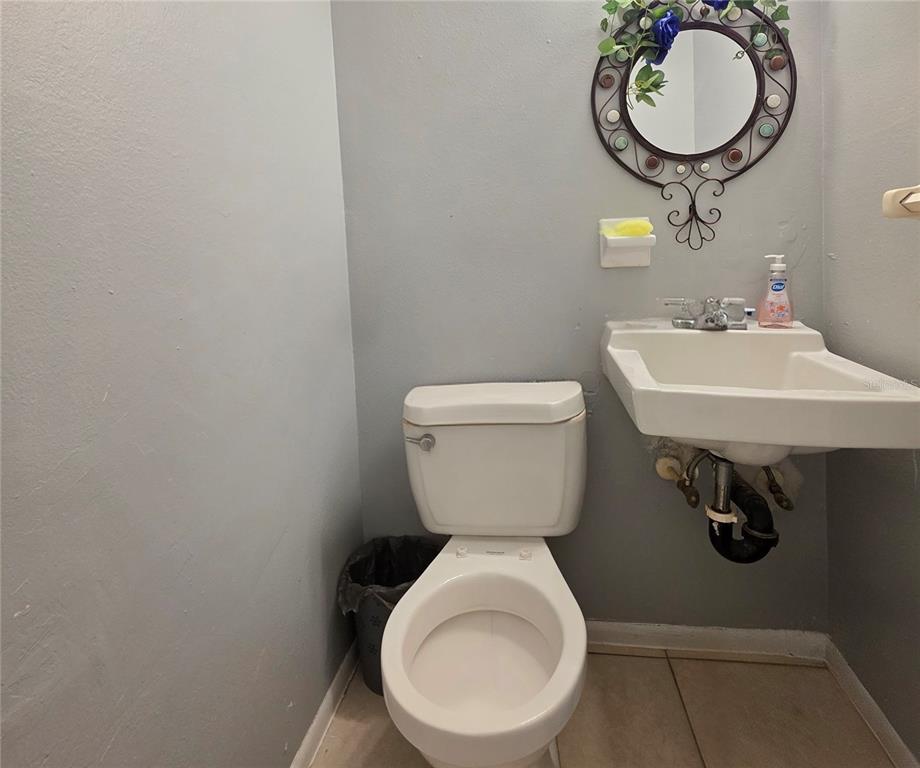 5462 Tenth Avenue Fort Myers, FL 33907 - Photo 9 of 20 a bathroom with a toilet a sink and mirror