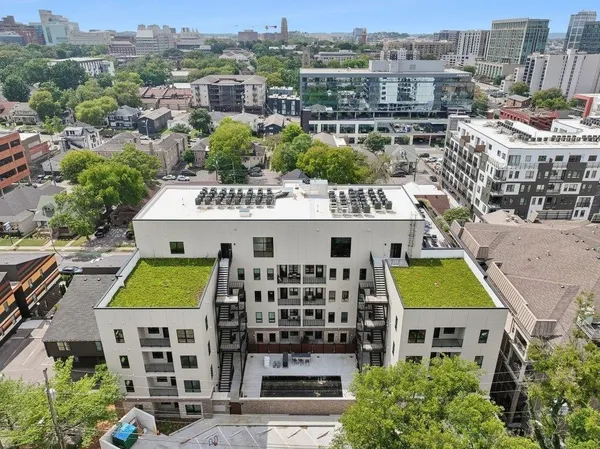 a view of a large building and a yard