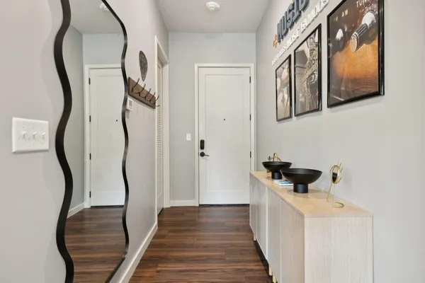 a view of a hallway with wooden floor and staircase
