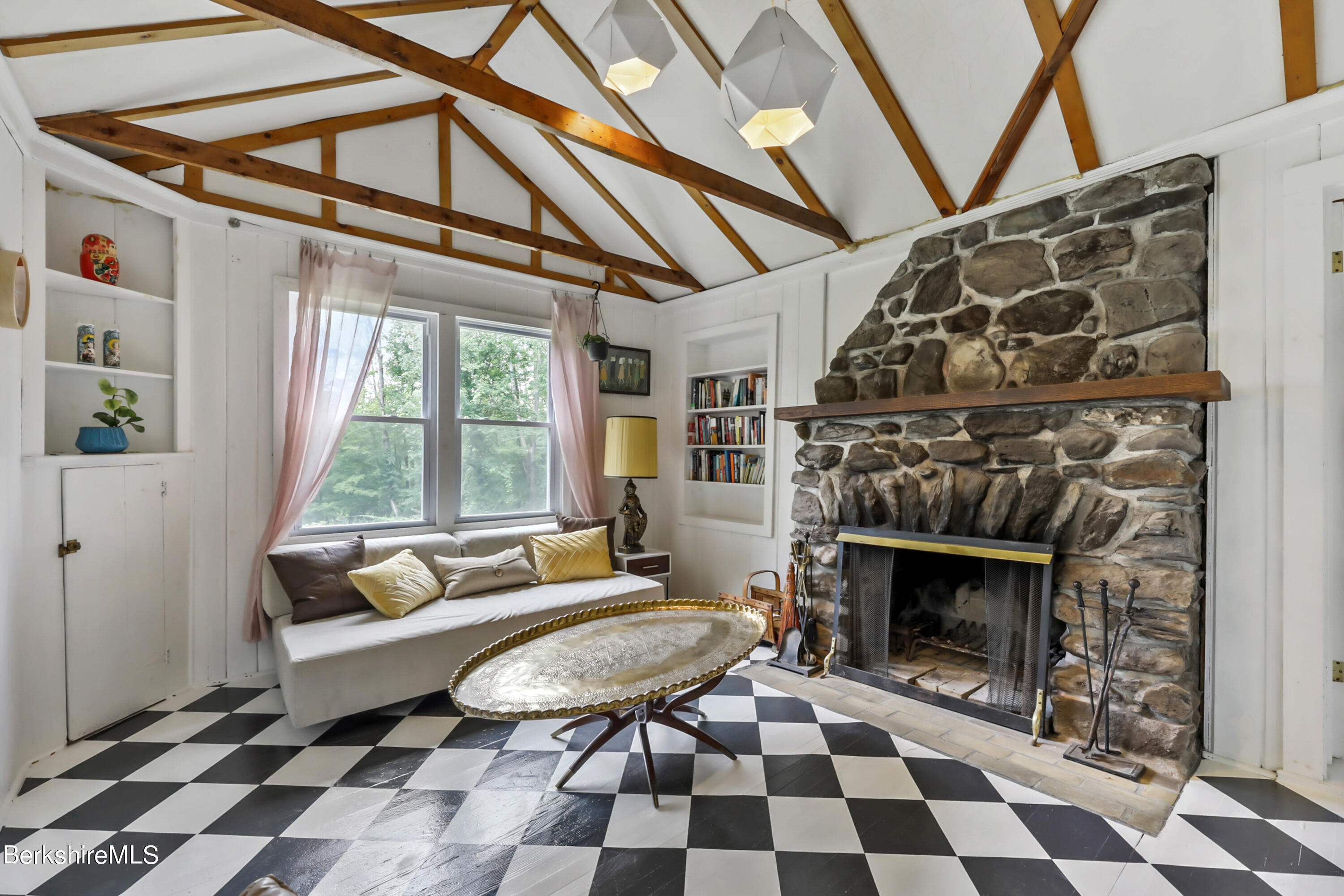 11 Mahkeenac Heights Road Stockbridge, MA 01262 - Photo 11 of 26 a living room with a black white checkered floor with a fireplace and a rug