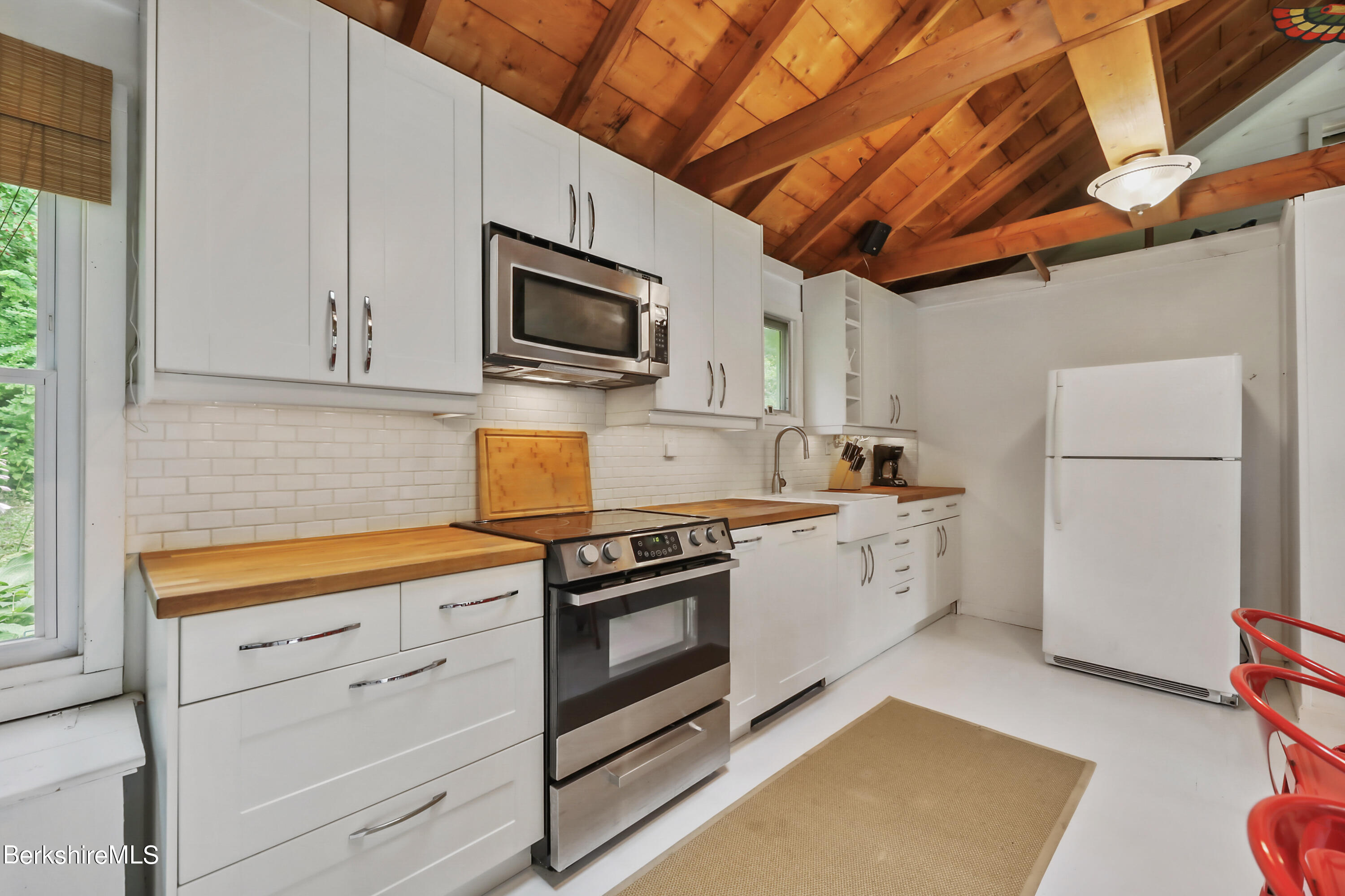 11 Mahkeenac Heights Road Stockbridge, MA 01262 - Photo 8 of 26 a kitchen with stainless steel appliances granite countertop a refrigerator a stove a sink dishwasher and white cabinets with wooden floor