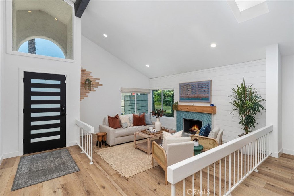 32772 Shipside Drive Dana Point, CA 92629 - Photo 20 of 56 a living room with furniture a fireplace and a floor to ceiling window
