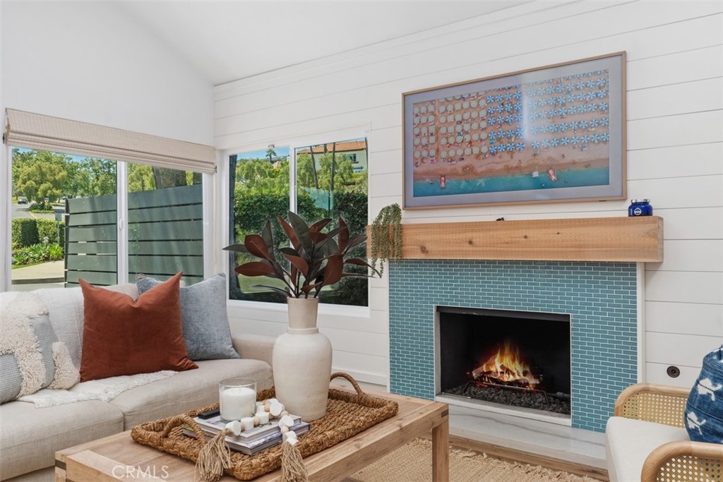 32772 Shipside Drive Dana Point, CA 92629 - Photo 21 of 56 a living room with furniture a fireplace and a large window