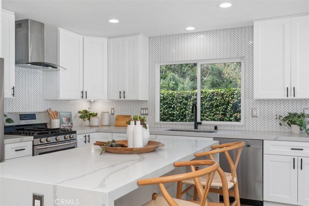 32772 Shipside Drive Dana Point, CA 92629 - Photo 8 of 56 a kitchen with stainless steel appliances granite countertop a stove a sink and white cabinets