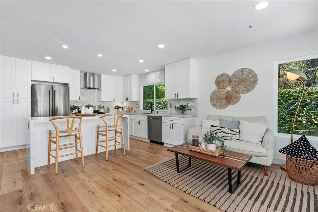 32772 Shipside Drive Dana Point, CA 92629 - Photo 9 of 56 a living room with white couches and kitchen view with wooden floor