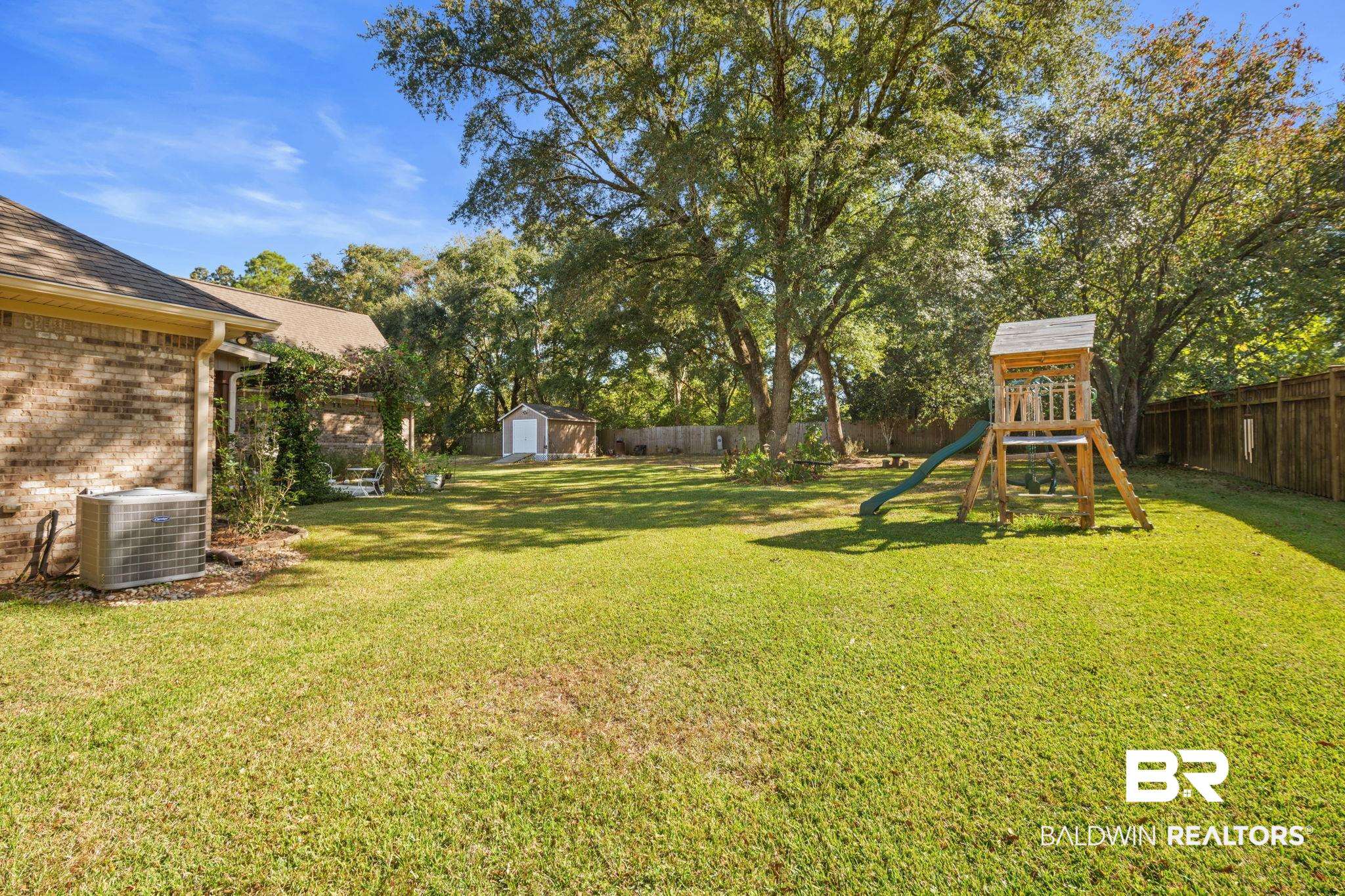 4331 Hamilton Oaks Lane Mobile, AL 36695 - Photo 29 of 38 View of yard with cooling unit, a storage shed, a playground, and an outdoor structure