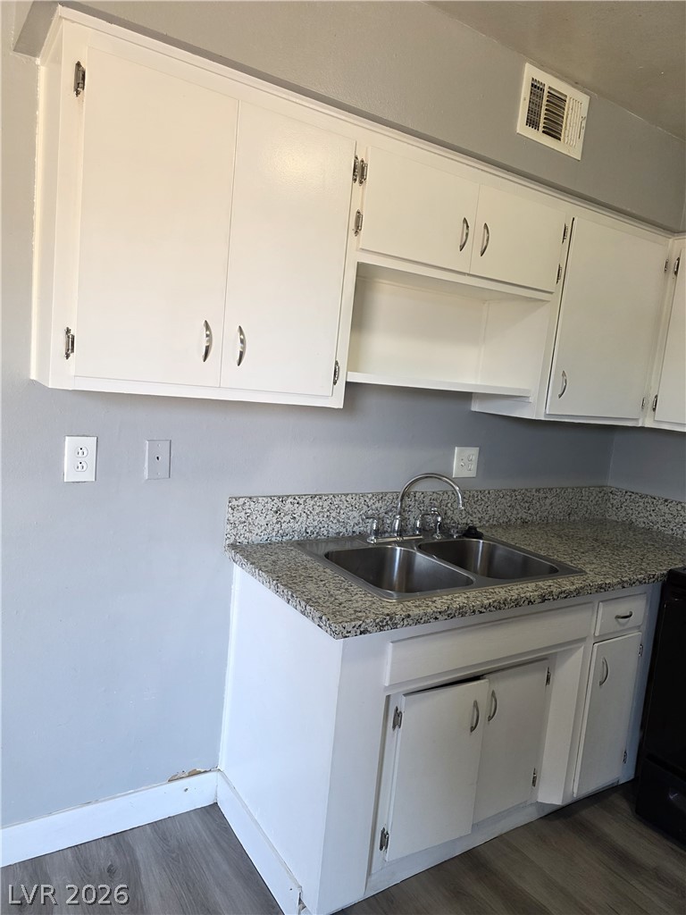 1089 East Desert Inn Road, Unit 3 Las Vegas, NV 89109 - Photo 10 of 15 A well-appointed kitchen features ample white cabinetry and durable granite counters.